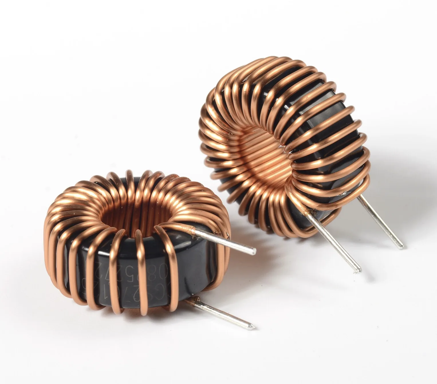 Two toroidal inductors wound with thick copper wire and straight leads